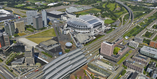 an aerial view of a train station in a city.