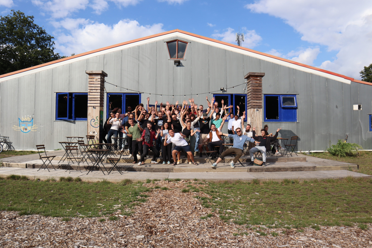 a group of people standing in front of a building.