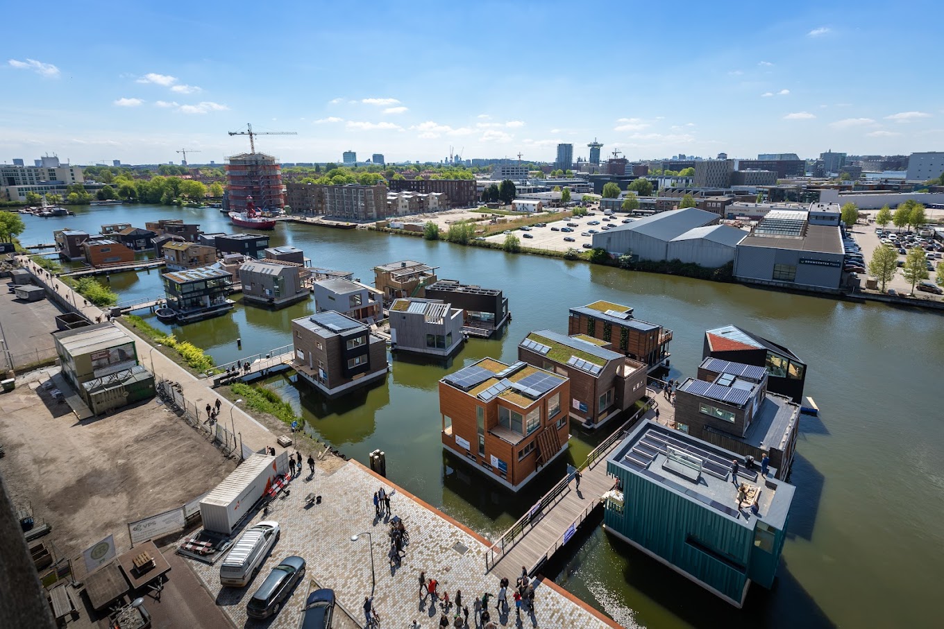 an aerial view of a canal with many boats.