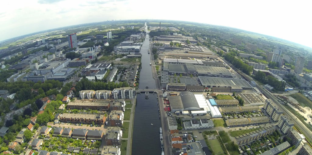 an aerial view of a waterway and a city.