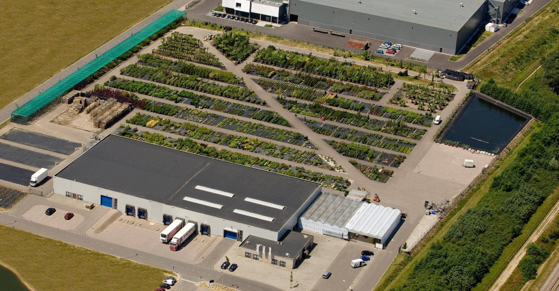 an aerial view of a factory building with many plants.