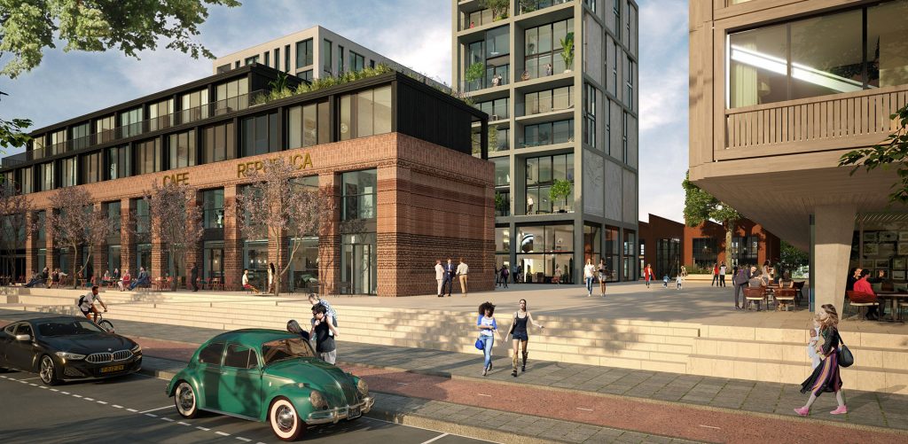 a green car driving down a street next to tall buildings.