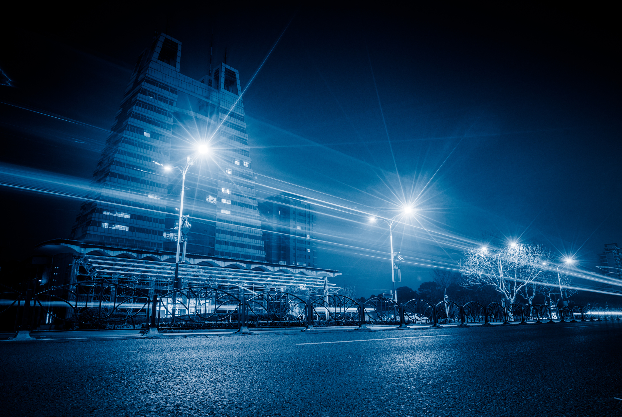 a city street at night with street lights.
