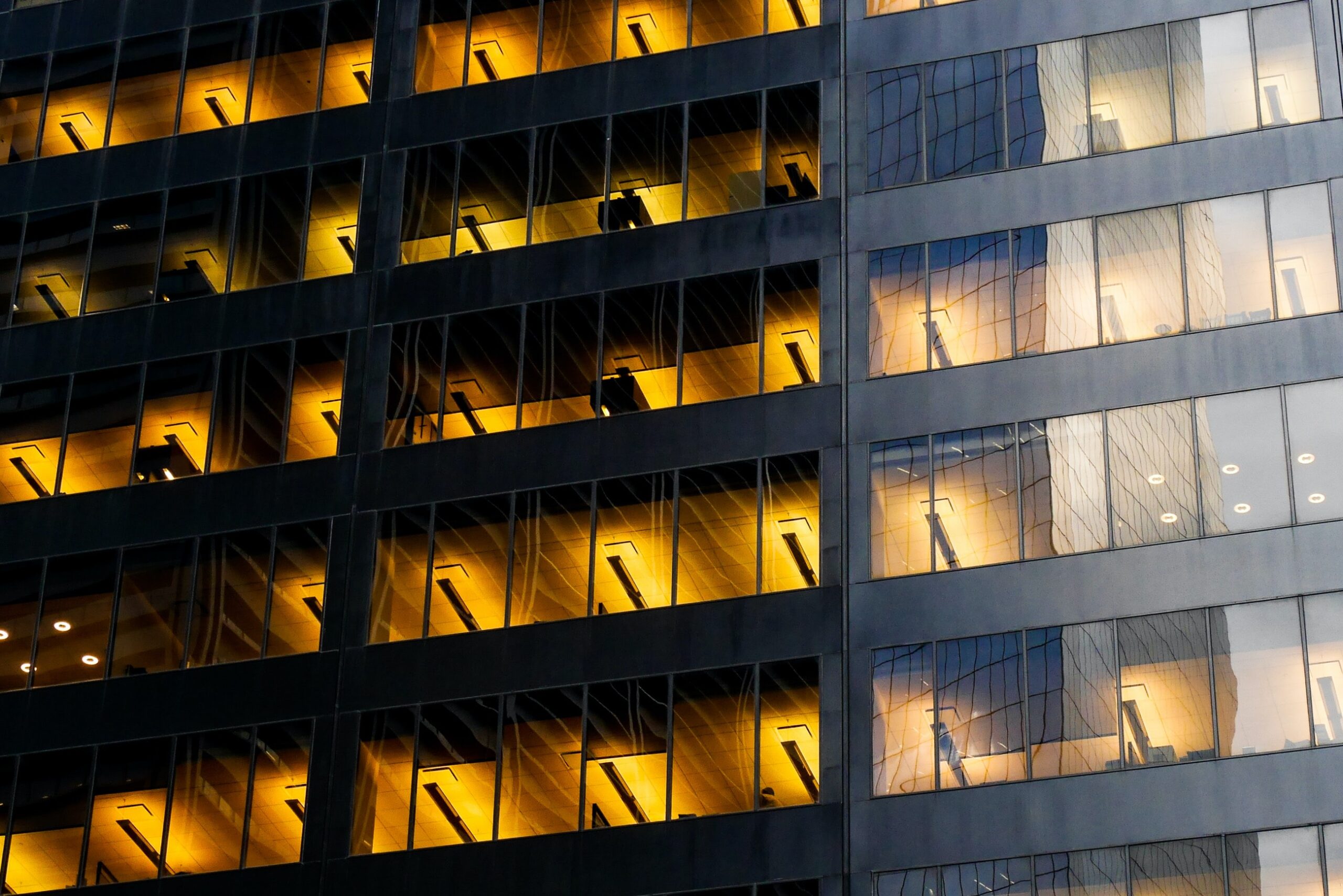 office building at night with yellow warm lights inside the building